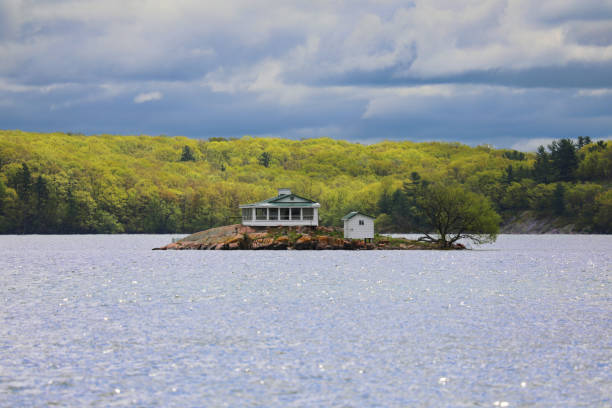 May 20, 2018 - Gananoque, Ontario, Canada: 1000 Islands Boat tour from Gananoque, Ontario, Canada to Boldt Castle, USA and beautiful houses on tiny islands seen along the way. USA architecture. Canadian architecture. Houses on a waterfront. Island living. Travelling in Canada and USA by boat.