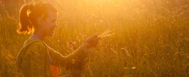 istock Girl picking flowers in spring 1131453601