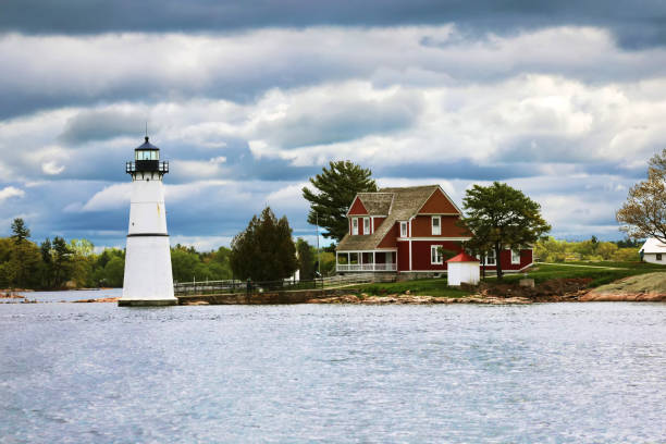 May 20, 2018 - Gananoque, Ontario, Canada: 1000 Islands Boat tour from Gananoque, Ontario, Canada to Boldt Castle, USA and beautiful houses on tiny islands seen along the way. USA architecture. Canadian architecture. Houses on a waterfront. Island living. Travelling in Canada and USA by boat.