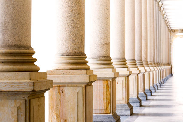 istock Colonnade, row of classical stone columns, background with copy spaced 1131453884