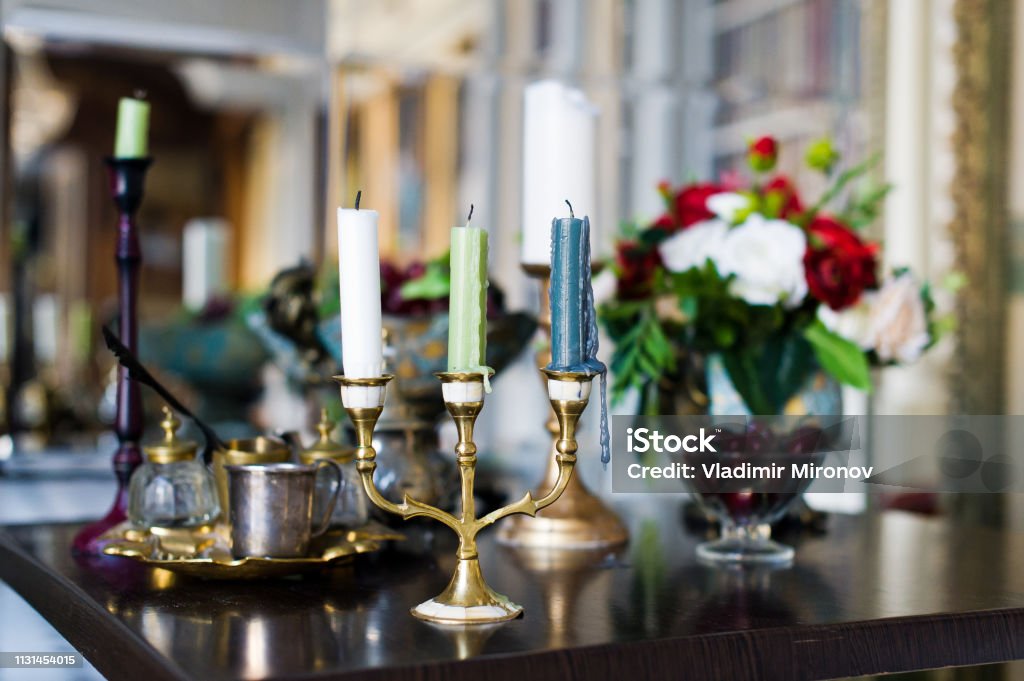 Vintage candelabra on the table in the interior. Vintage candelabra on the table in the interior Antique Stock Photo