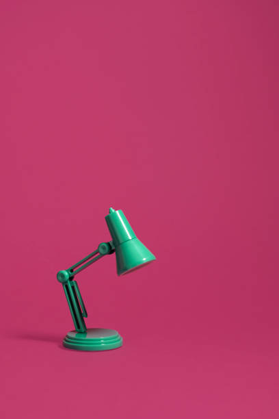 istock Retro green desk lamp on pink 1131454114