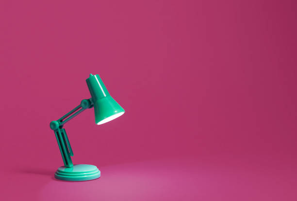 istock Retro green desk lamp on pink 1131454160