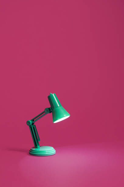 istock Retro green desk lamp on pink 1131454227