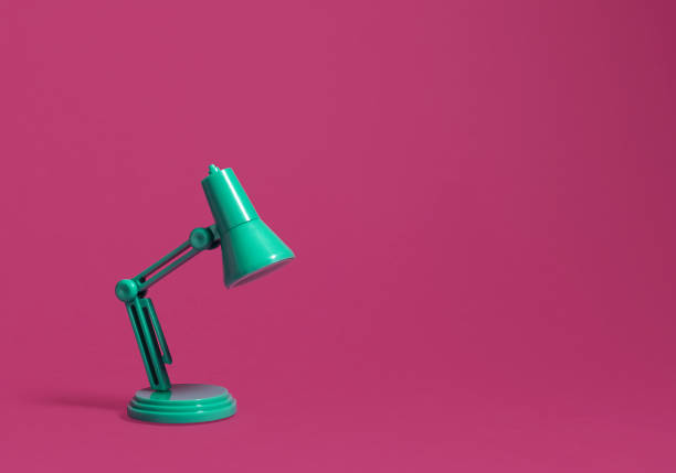 istock Retro green desk lamp on pink 1131454236