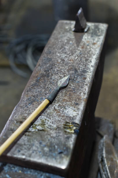 istock The blacksmith forges an arrowhead hammer on the anvil. 1131455026