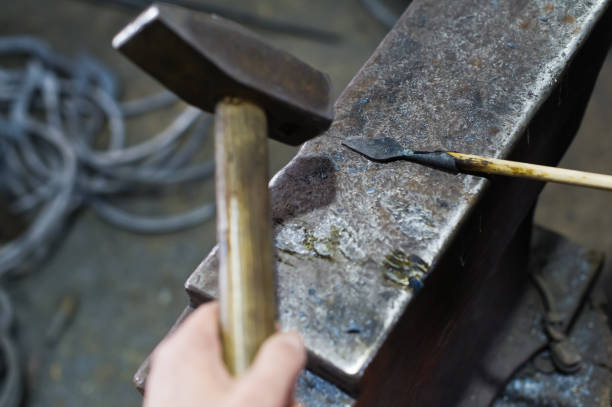 istock The blacksmith forges an arrowhead hammer on the anvil. 1131455077