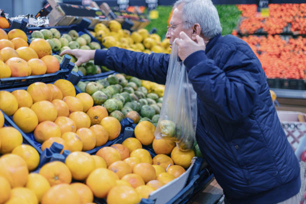 istock Seniorman shopping some fruit  with plastic bag 1131455274