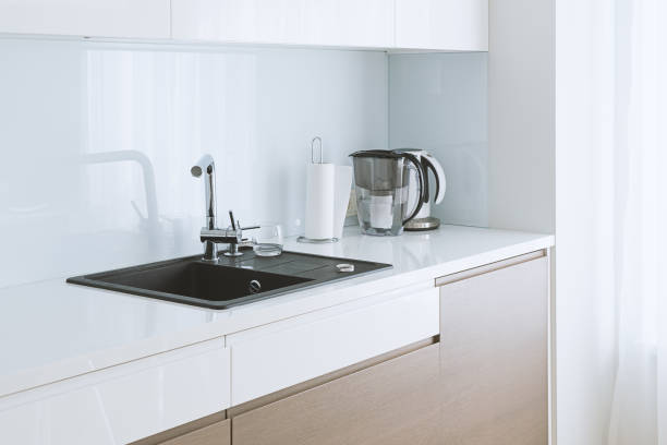 istock View of modern spacious and light kitchen with dark sink and beige cupboard with copy space 1131457640
