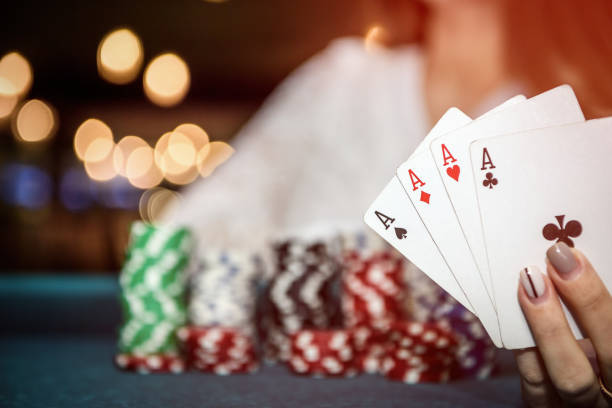 istock Female hands with playing cards and poker chips 1131457846