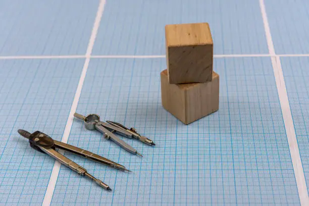 Millimeter paper with draw tools and wooden blocks