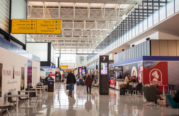 Austin Bergstrom Expansion Opens On February 21st, 2019, Austin Bergstrom Airport opened 9 new gates to travelers. The $350 Million Dollar expansion took over 2 years to complete. This photograph features travelers exploring and walking through the new section of the airport in Austin, Texas. austin airport stock pictures, royalty-free photos & images