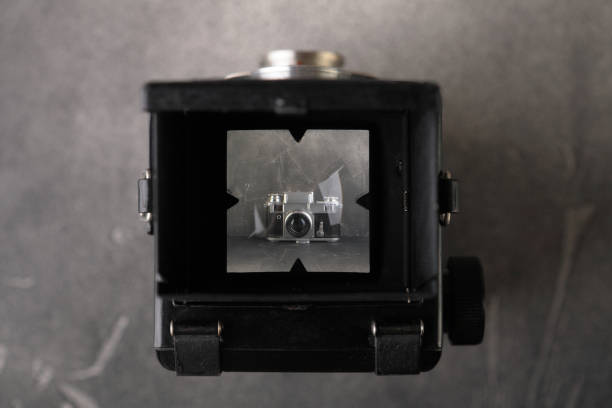 istock The old medium-format scaling film camera on grey cement background. TLR film camera. 1131460952