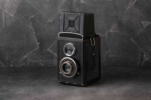 istock The old medium-format scaling film camera on grey cement background. TLR film camera. 1131460964