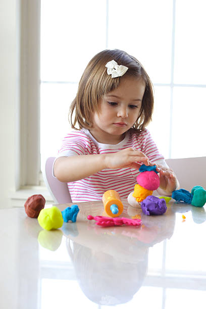 istock Girl playing with play dough 113146252