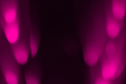 Abstract background with defocused lights in pink tones. Motion blur effect, space for copy.