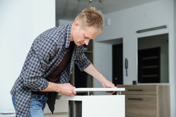 istock The man assembles the furniture at home. 1131467114