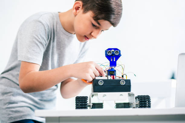 istock Close up of a little robot standing on the table 1131467216