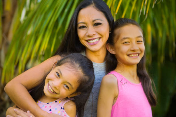 portrait de famille hawaïen en plein air avec la mère, deux adolescentes préadolescentes - hawaiian ethnicity photos et images de collection