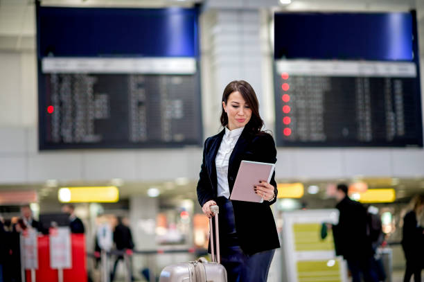 istock Female passenger using digital tablet at airport 1131469386