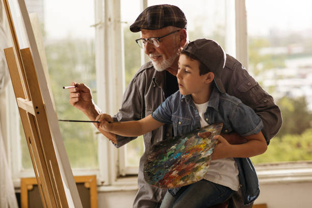 istock Elderly man teaching arto to young boy 1131470289