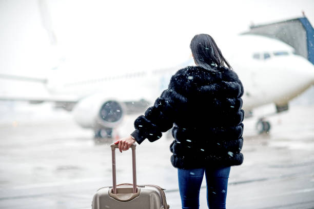 istock Young beautiful woman going to private jet airplane 1131470864