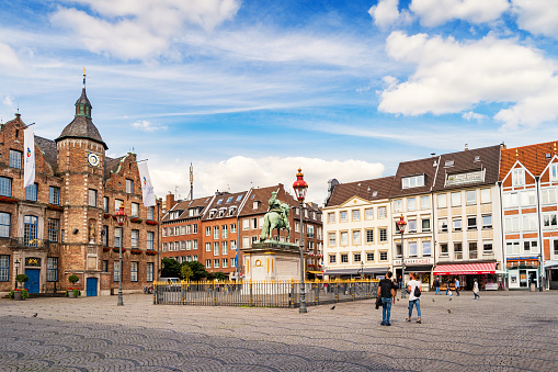 People look at the statue of Jan Wellem located in front of the Old Town Hall on Marktplatz in Old Town Dusseldorf,  North Rhine-Westphalia, Germany.