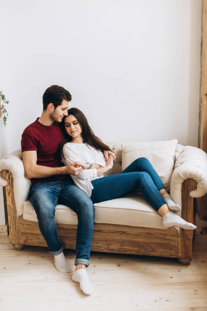 istock Loving each other spouses spend time together and hugging on the sofa 1131473107