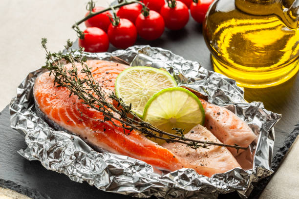 istock Raw fish with thyme and lime in foil ready for baking 1131473238