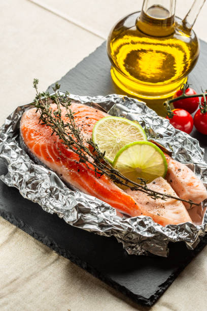 istock Uncooked red fish with lime and thyme on the foil 1131474017
