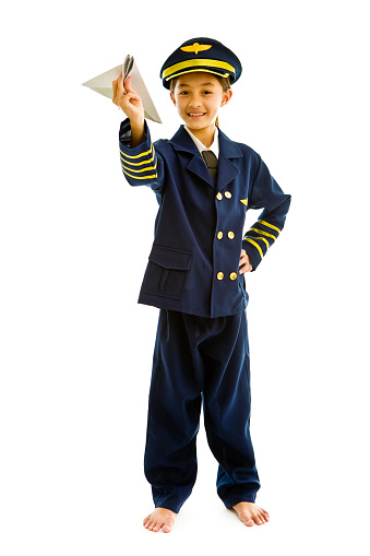 Portrait of a 10 years old young ethnic girl with career aspiration of being an airline pilot on white background. She is wearing a pilot uniform costume, looking at camera
