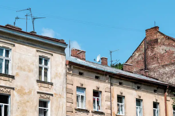 Lviv, Ukraine exterior of residential buildings in historic Ukrainian city in old town architecture during day with antenna cables wires power lines hanging and blue sky