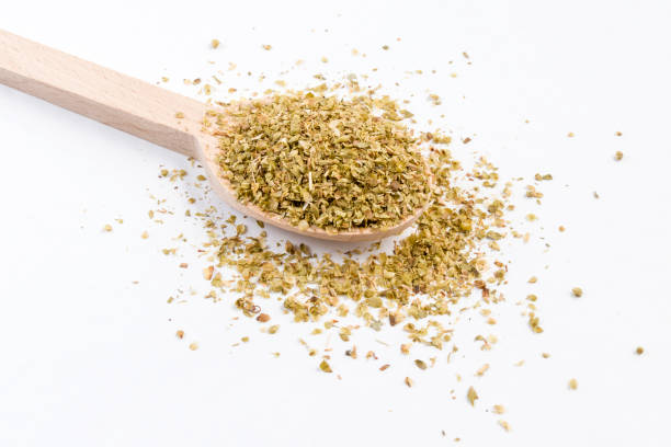 istock oregano herb in wooden spoon isolated on white background. 1131487873