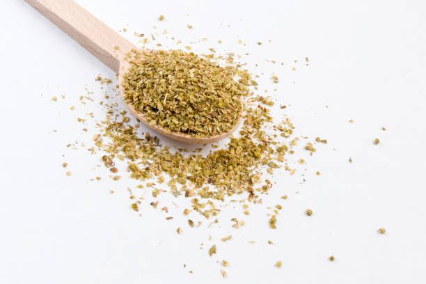 istock oregano herb in wooden spoon isolated on white background. 1131487919