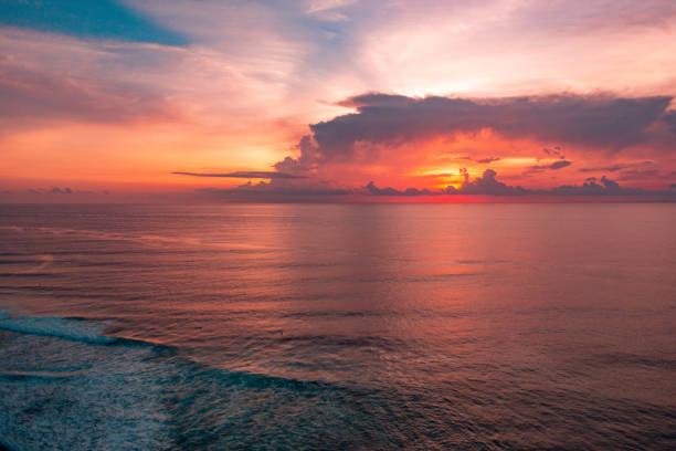istock amazing scarlet sunset wuth a big clouds on beautiful tropical Bali beach 1131508438