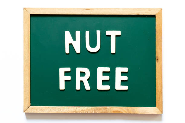 istock Green blackboard and wood frame with word nut free on white background 1131508488