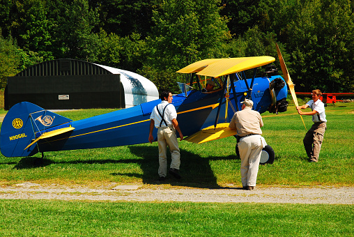 Rhinebeck, NY, USA September 4, 2009 An airplane crew manually spins the propellers to prepare a Davis D1W for take off in Rhinebeck, New York