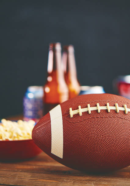 time to watch football on tv. popcorn with american football - american football football food snack imagens e fotografias de stock