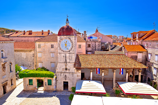 Trogir, Croatia, November 11 2018: UNESCO Town of Trogir main square panoramic view in Dalmatia, Croatia. Historic clock tower is famous tourist site.
