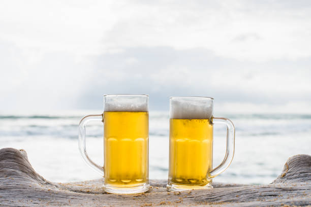 istock Glass of beer on a beach 1131521366