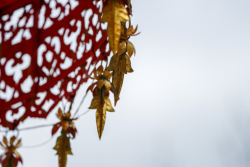 close up vintage Red gold tranditional Thail shading (like an umbella) decorated with gold mobile around it.