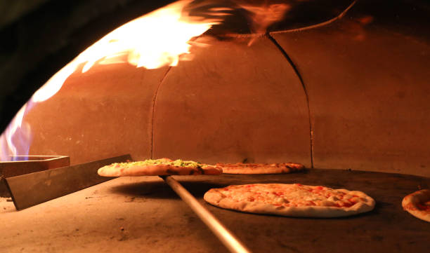istock fire and pizza inside an oven in the pizzeria 1131531760