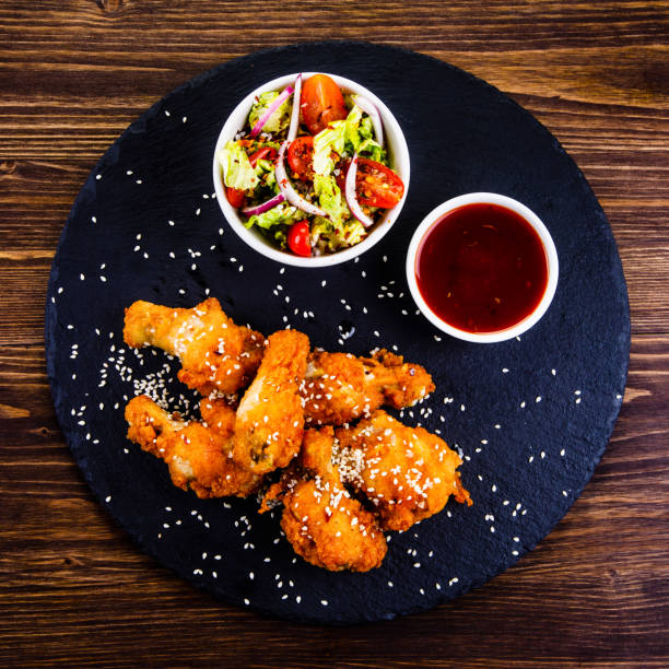 istock Fried chicken nuggets and vegetables 1131534243