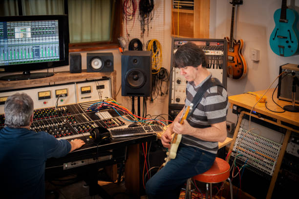 istock Sound Engineer, Musician Playing Electric Guitar in Analog Sound Studio 1131536063