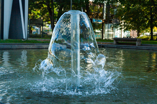 Glass and circular futuristic water fountain in San Francisco during springtime day