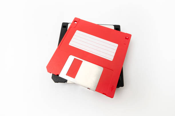 istock Piled obsoleted black diskettes with red diskette on the top 1131540169