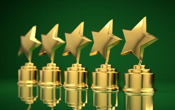 istock Five golden rating star in green background. 1131542648
