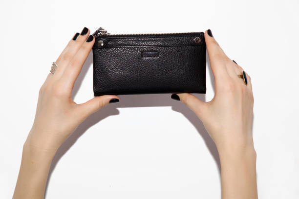 istock Close-up of hands holding a black wallet. 1131544527