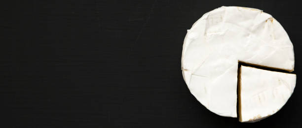 istock Cheese camembert or brie on black background. Milk production. Top view. Flat lay. Copy space. 1131544794
