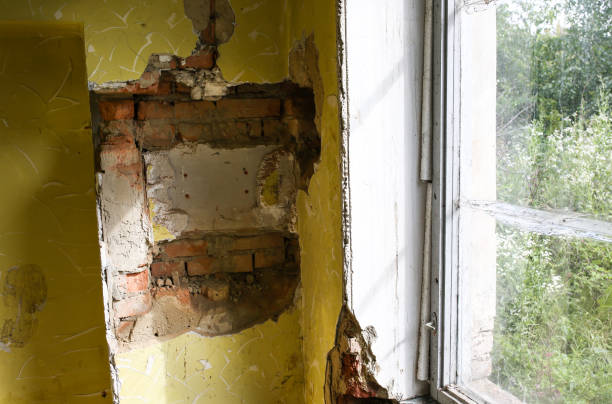 istock Old broken window and bricks wall in the abandoned house. 1131544990